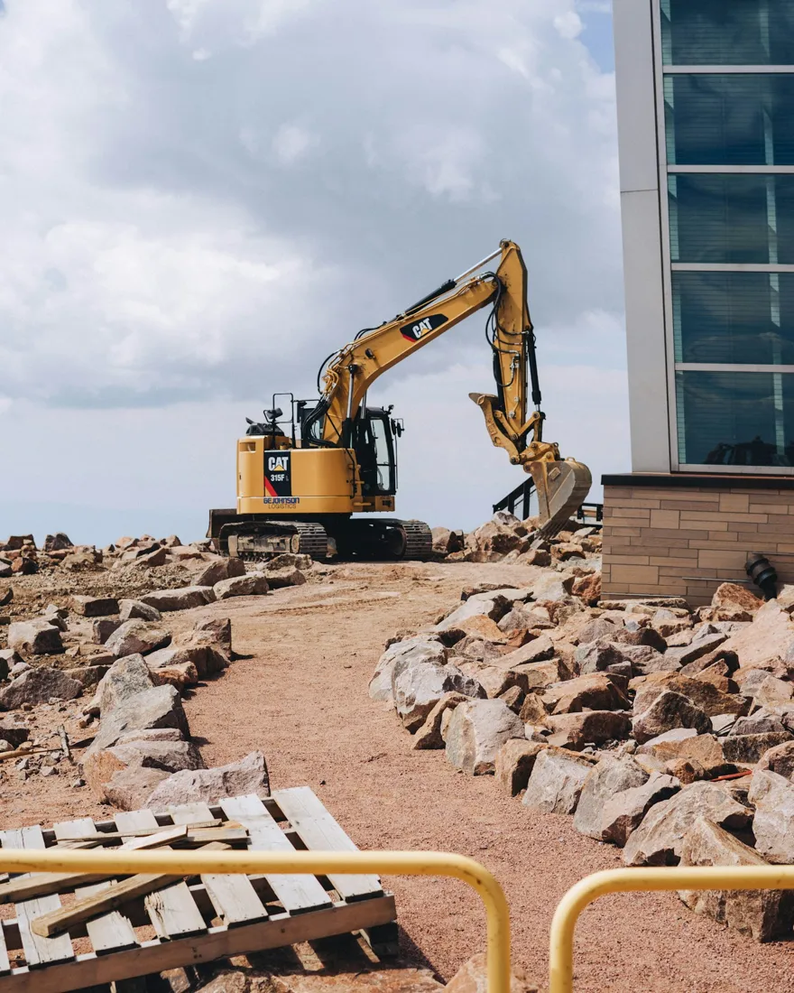 Excavator beside a building site