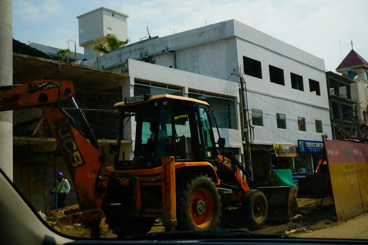 Backhoe loader beside a building