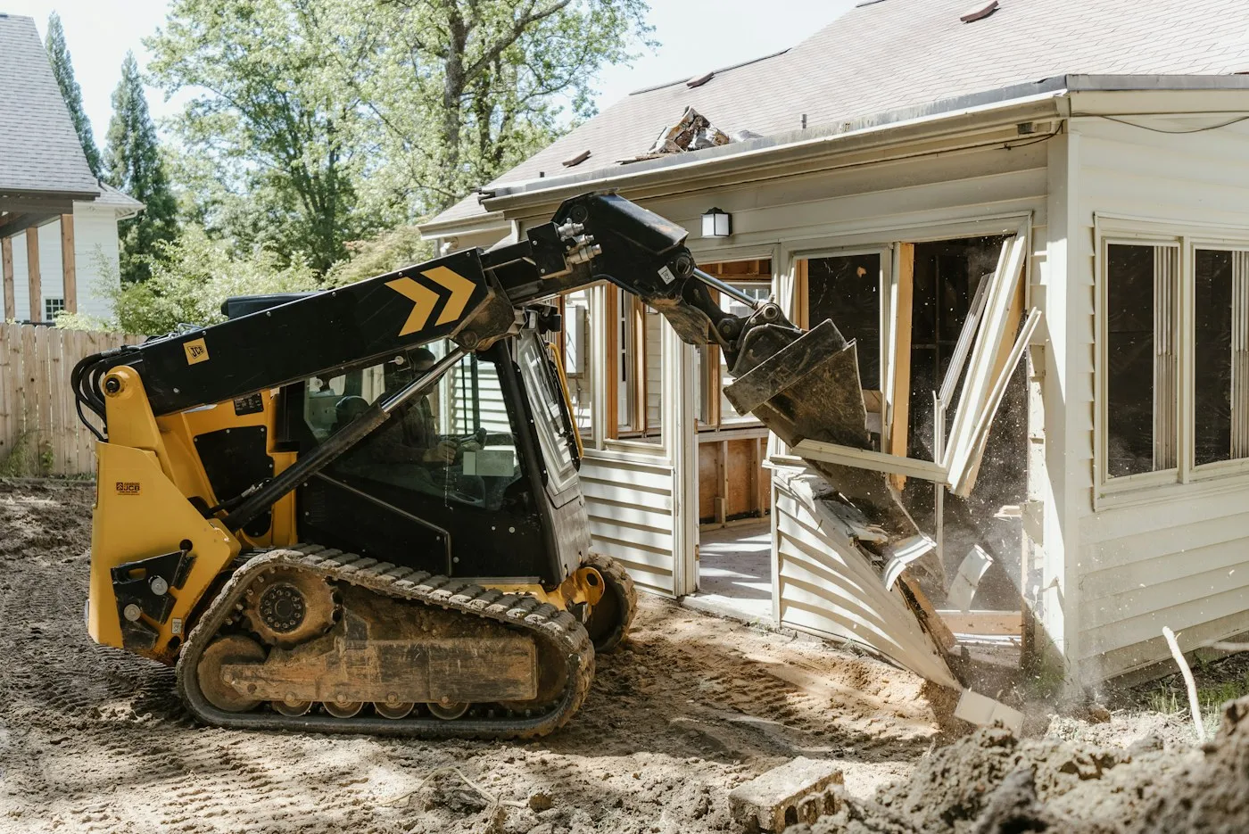 Compact loader at a residential renovation site