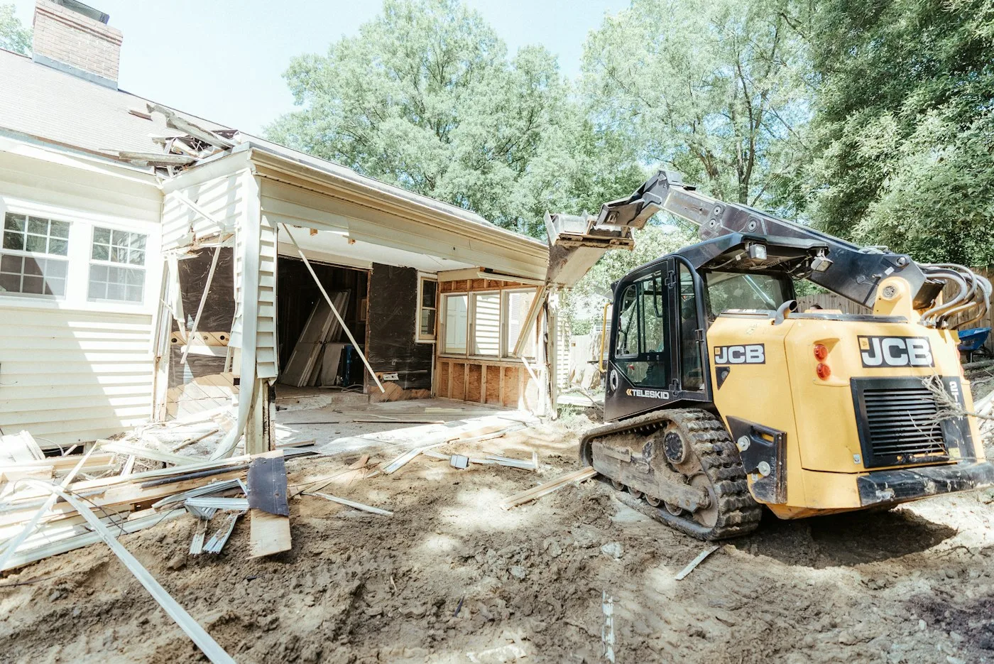 Compact tracked machine at an occupied property