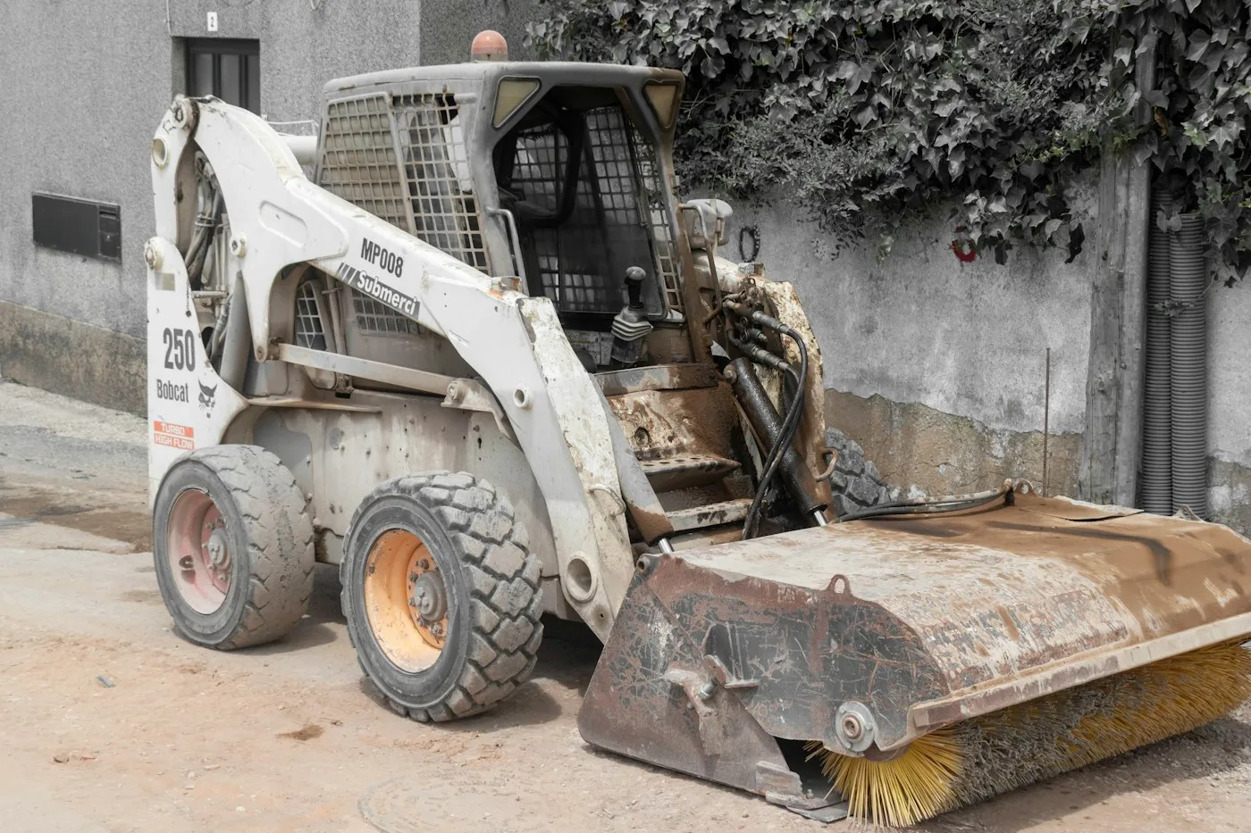 Loader bucket and tracks at a worksite