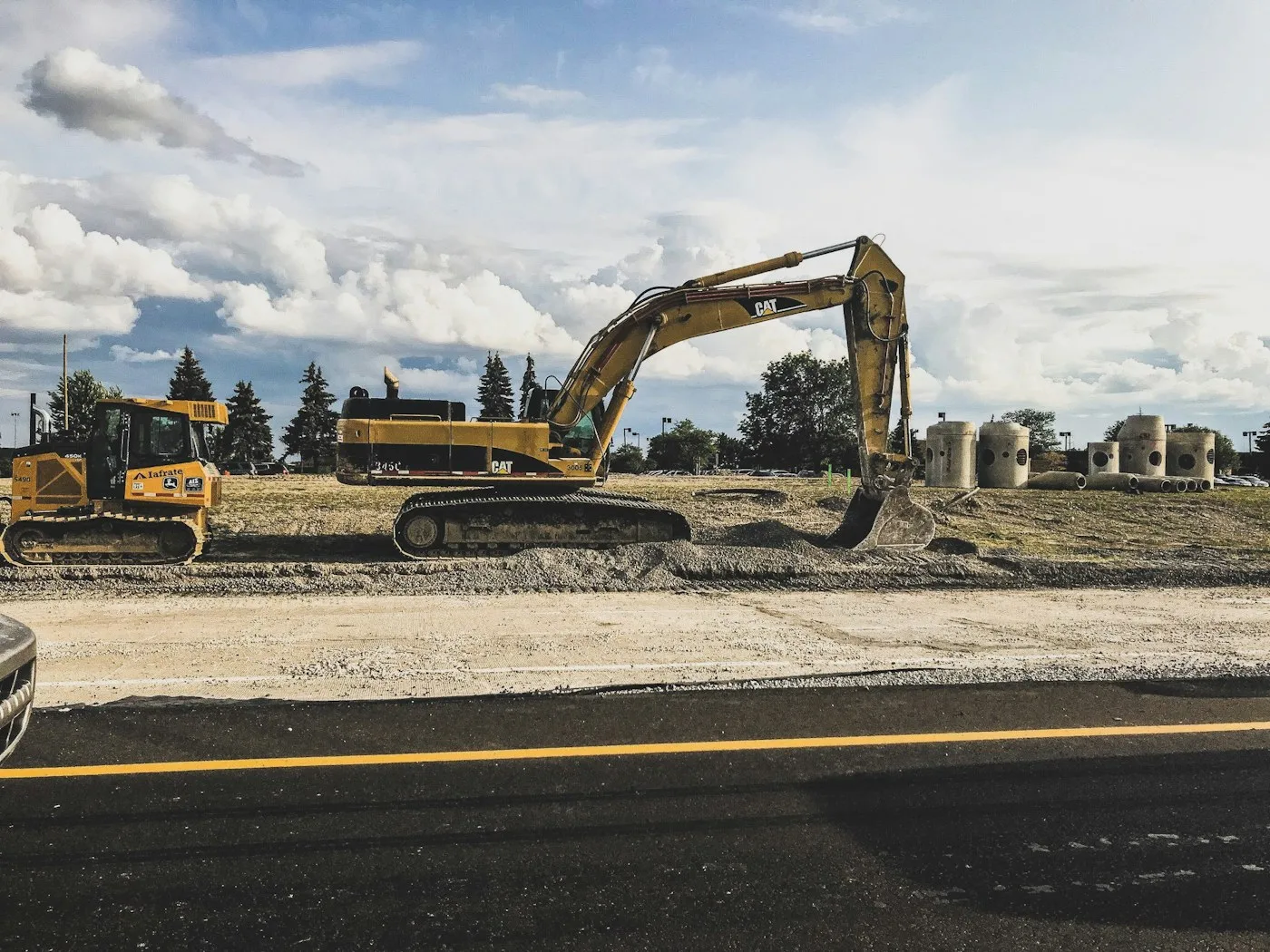 Tracked excavators on a cleared construction site